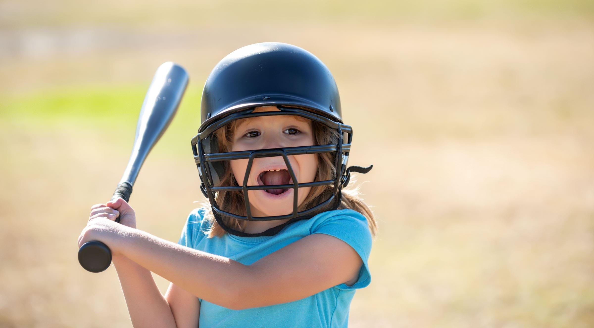 Kid baseball ready to bat. Child batter about to hit a pitch during a baseball game